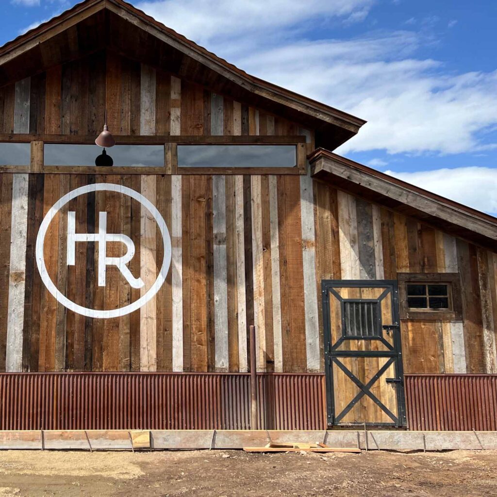 Large salvaged wood barn with custom barn doors