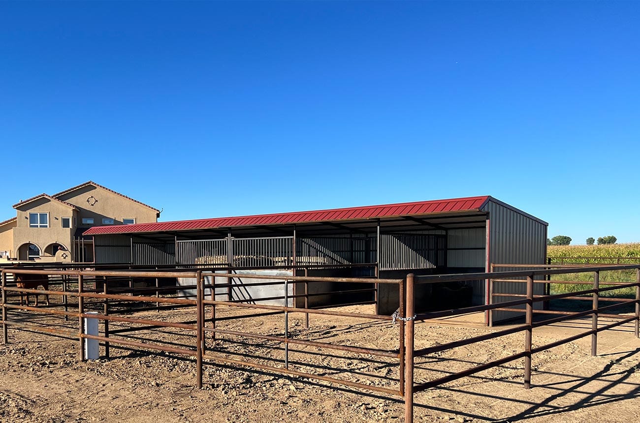 Portable loafing shed with pipe fence runs