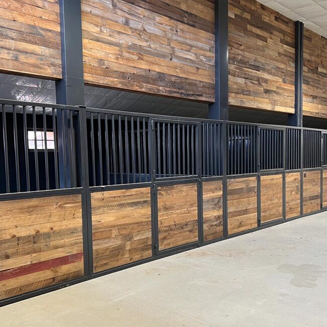 Custom barn stalls with dark wood and black metal framing