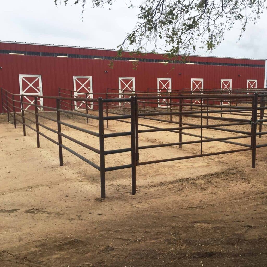 Weld-up metal building red barn with horse runs.